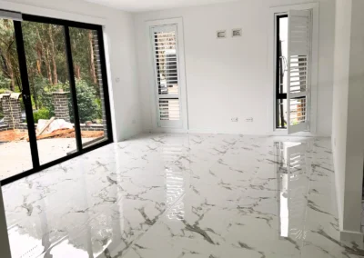 Bright, empty room with glossy marble-patterned floor tiles